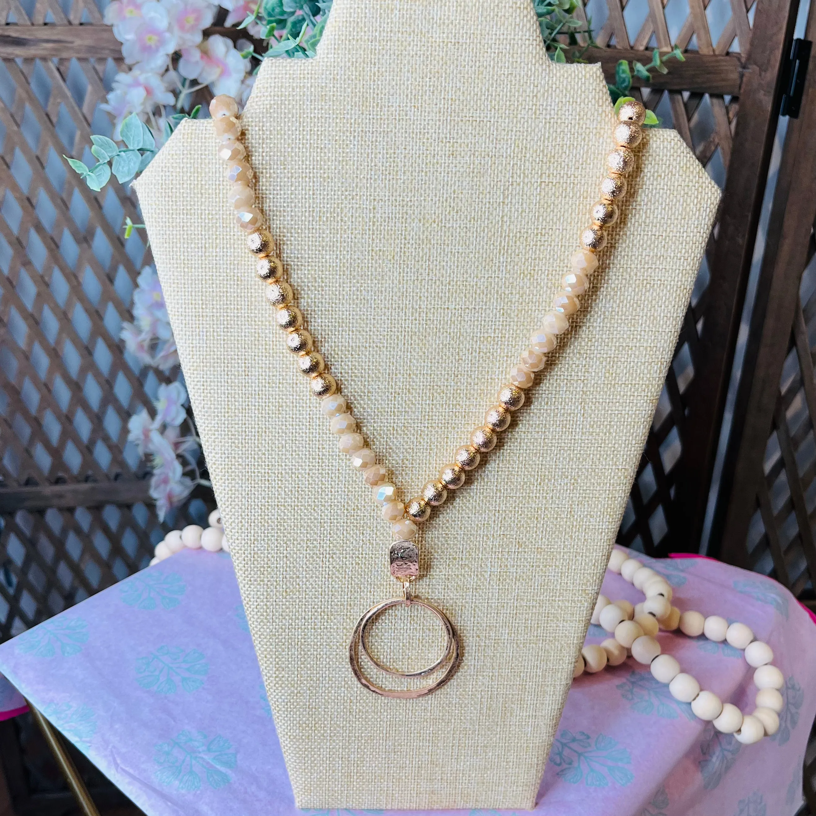 long beaded gold necklace with pendant